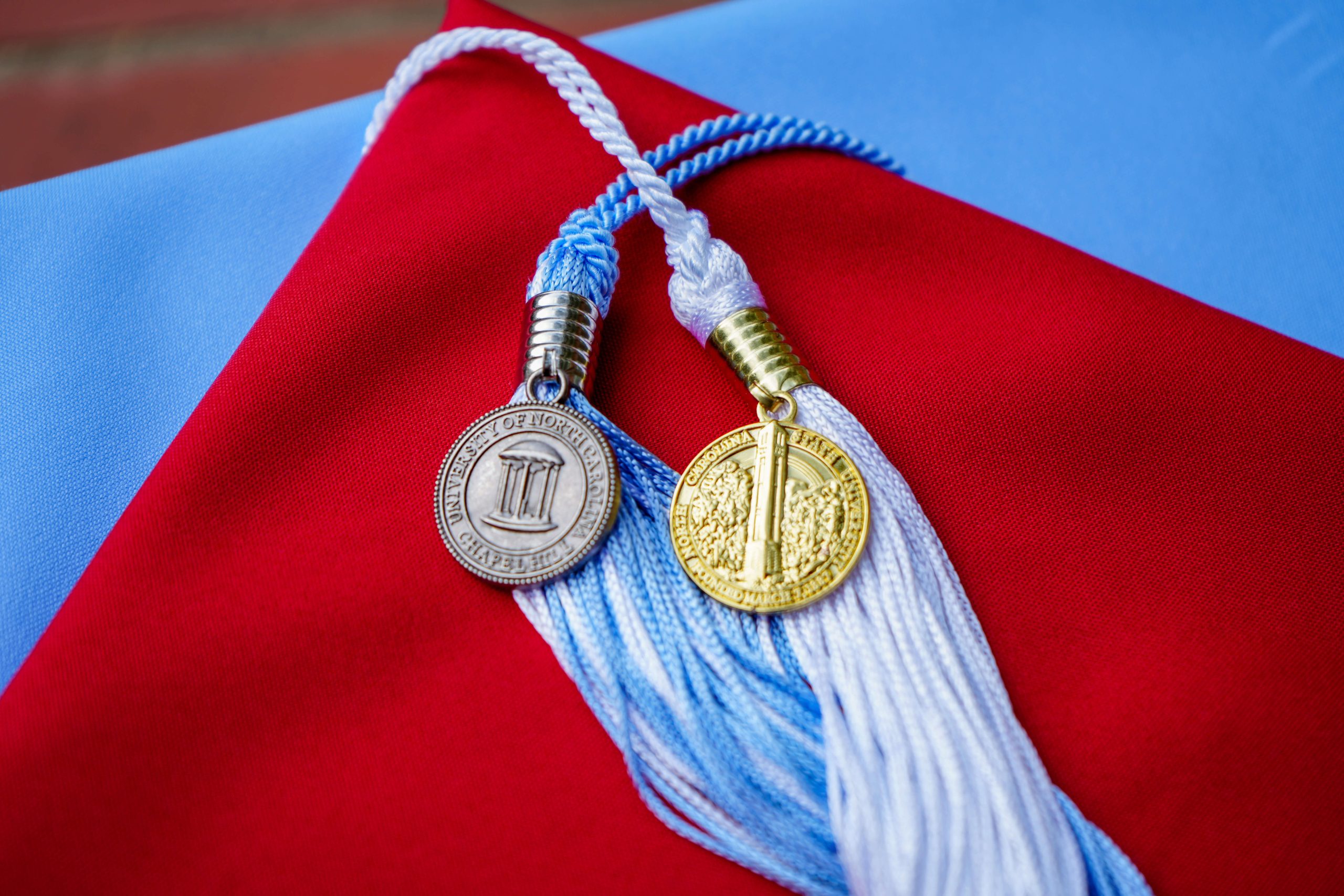 Photo of UNC and NC State Graduation Caps and Tassels
